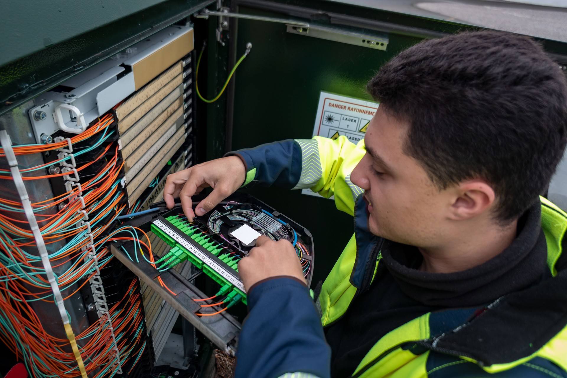 Fiber optic technician restores connection after cabinet failure